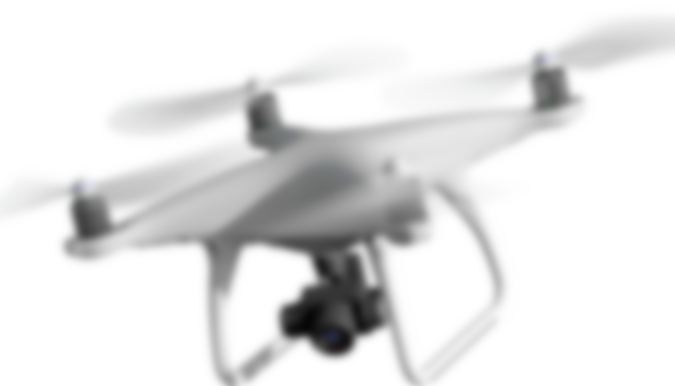 空を飛ぶドローンの画像