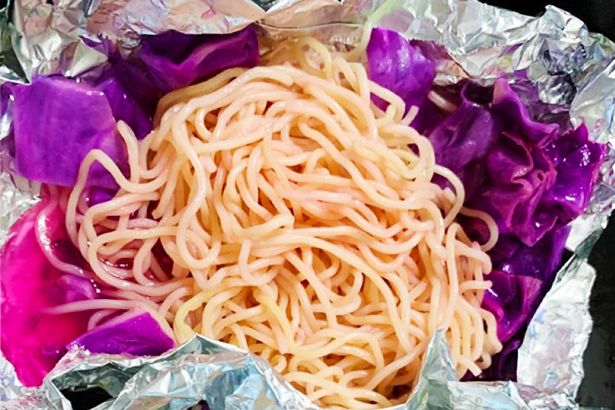 紫キャベツと麺がアルミホイルに包まれている