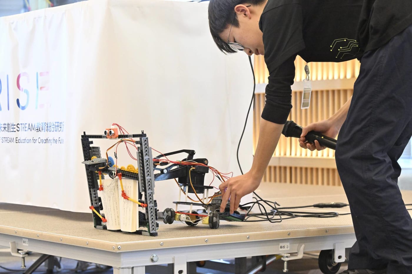 クリエイティブロボティクスコンテスト2025テーマパフォーマンスで近視ブロックロボットを披露する参加者