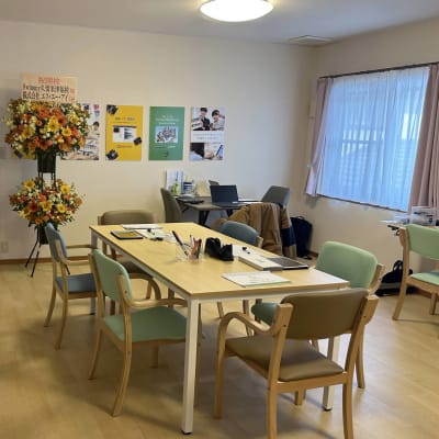 広々とした空間で、木のぬくもりを感じるデスクとカラフルな椅子が並ぶ、清潔感あふれる教室です。