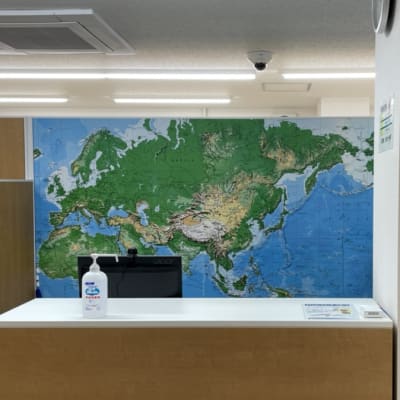 受付はこちらです（階段を上って左手に入口の扉があります）