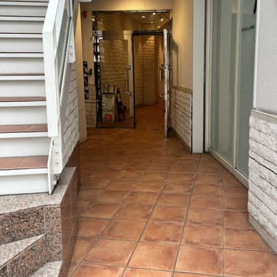 外階段の右手奥通路よりエレベーターを利用してお越しください