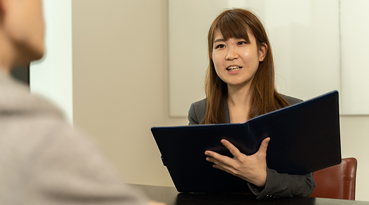 女性キャリアカウンセラーが生徒に対してヒアリングを行っている