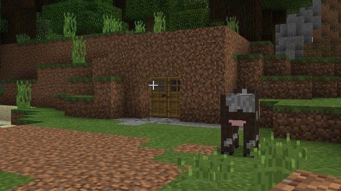 マインクラフトのゲーム画面。家の前に牛が立っている様子